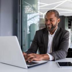 Black business owner working on a computer